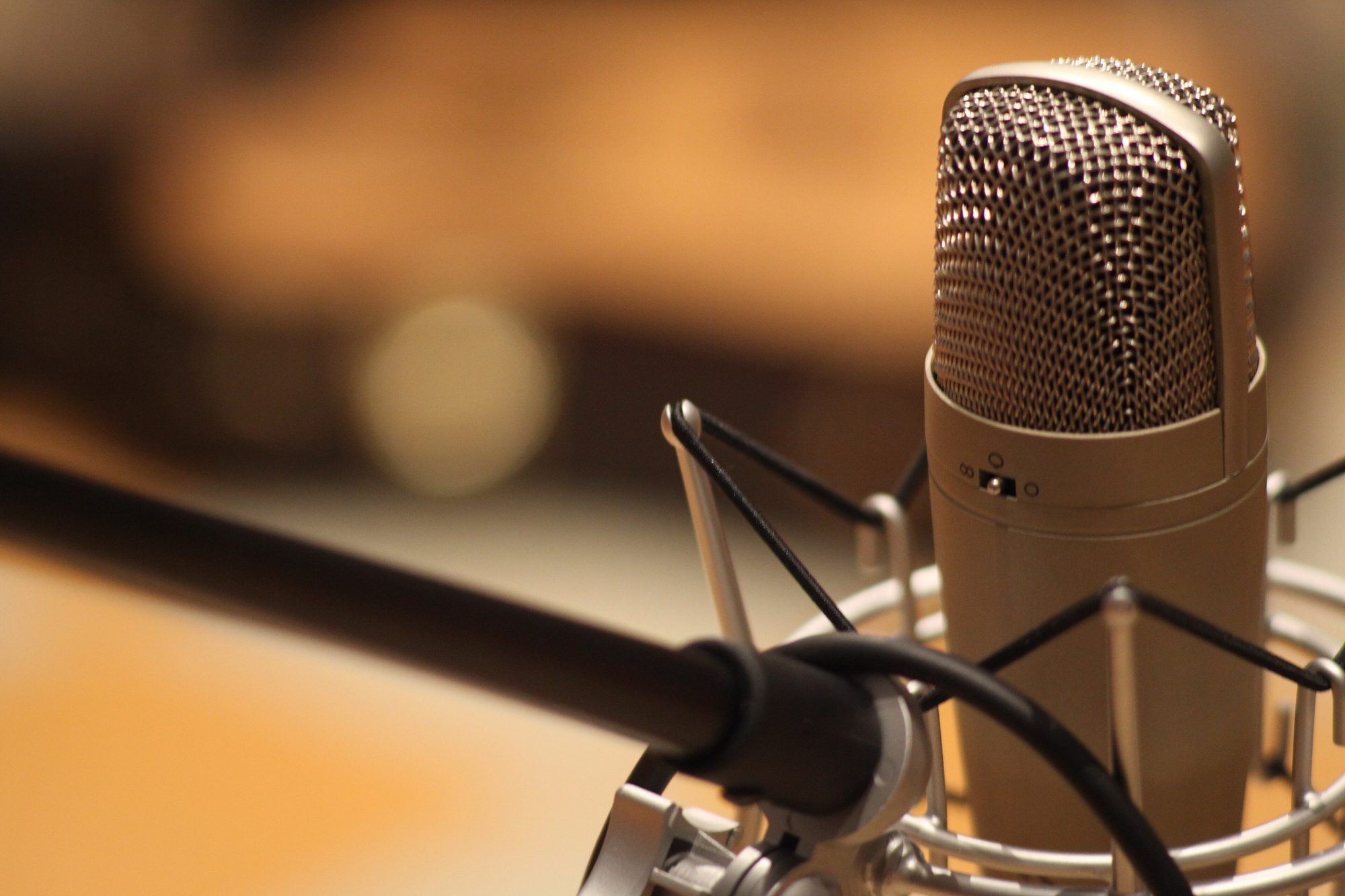 A measurement microphone on a stand in an empty auditorium