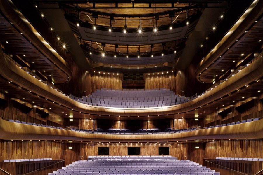 A concert hall balcony front, its underside shaped to return early sound to the seats below