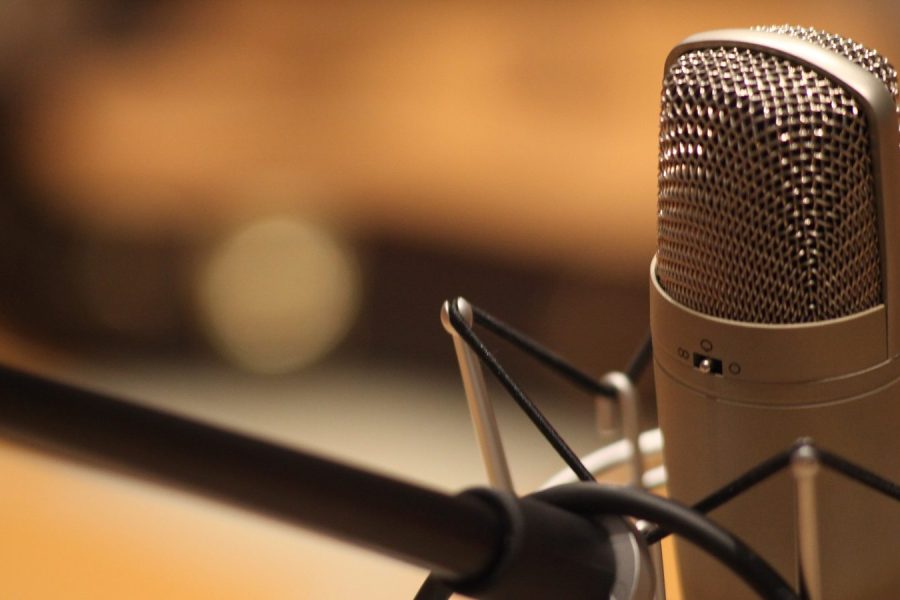 A measurement microphone on a stand in an empty auditorium