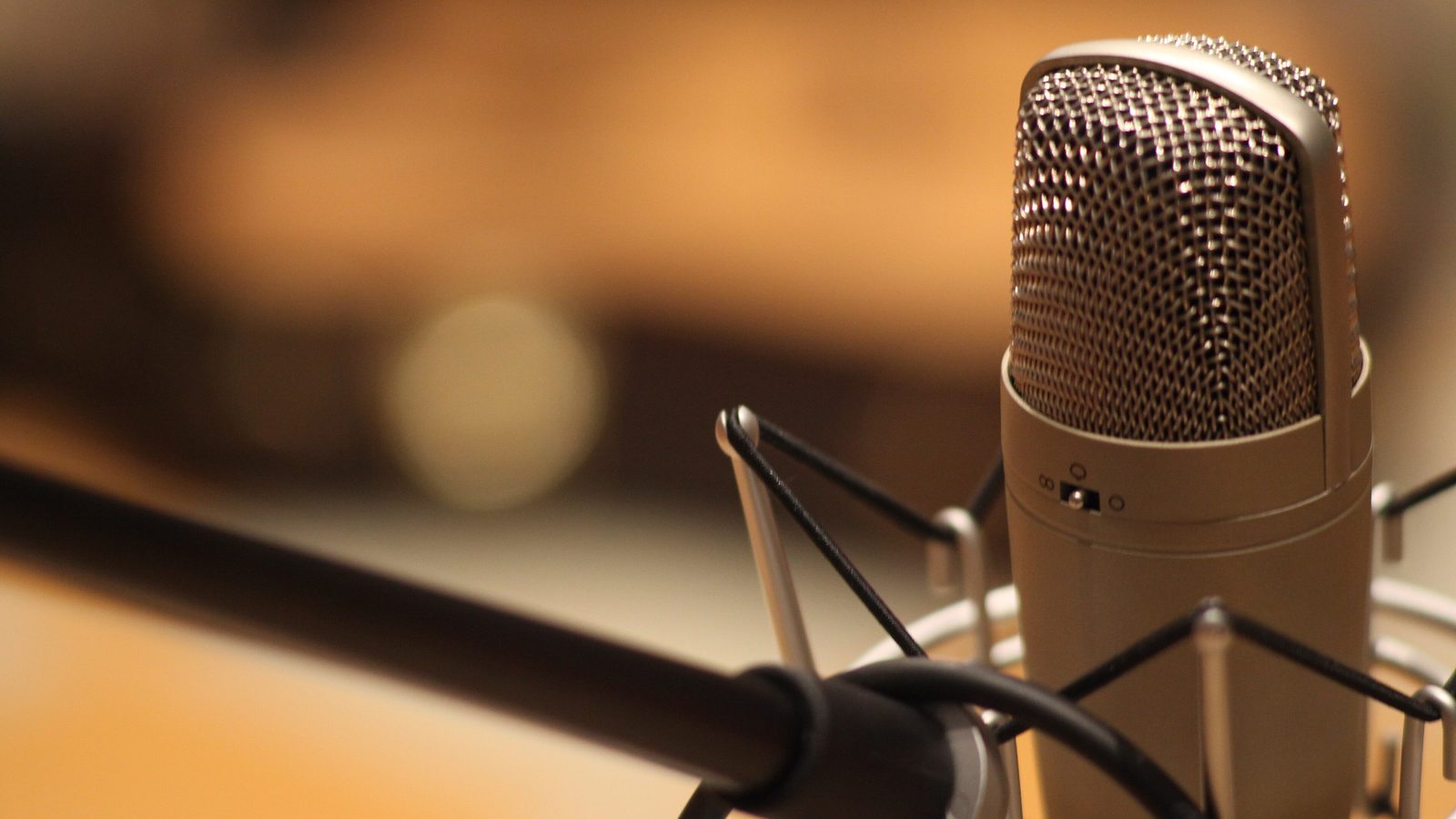 A measurement microphone on a stand in an empty auditorium